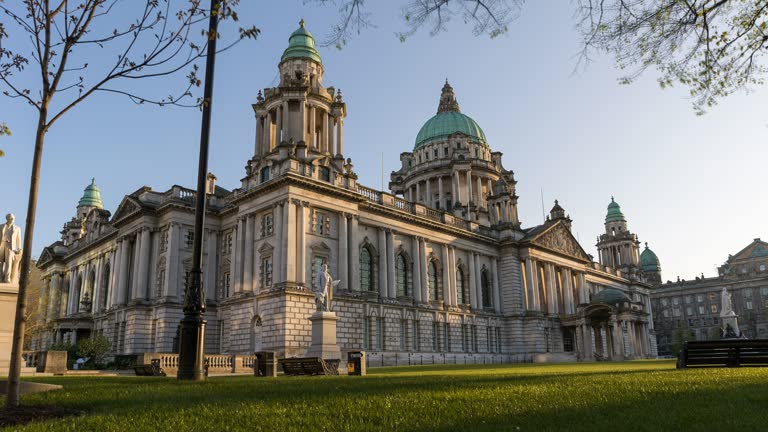 Golden sunset light and shadows creeping down Belfast City Hall