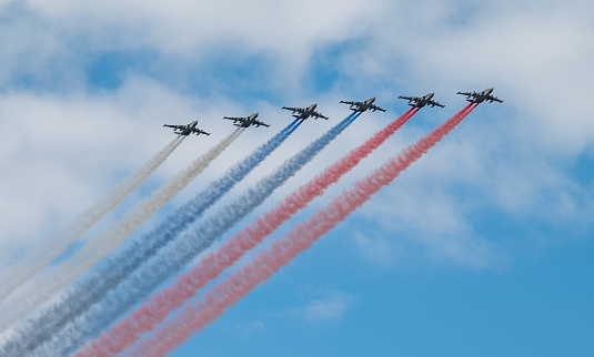 July 31, 2022, St. Petersburg, Russia. Sukhoi Su-25 attack aircraft with released smoke in the colors of the Russian flag at the Main Naval Parade in honor of the Day of the Russian Navy in St. Petersburg.