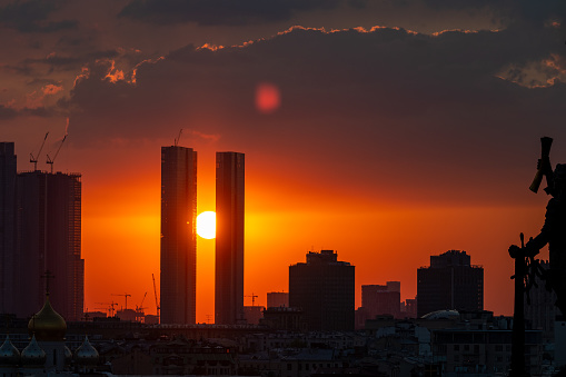 August 16, 2022, Moscow, Russia. The setting sun over the skyscrapers of the Moscow City office center on a summer evening. Sunset.