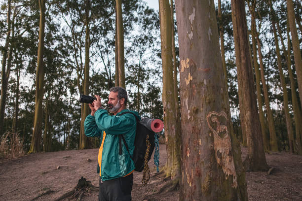 istock Active senior hiker taking photos in the wilderness 1460323499