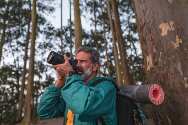 istock Active senior hiker taking photos in the wilderness 1460323501
