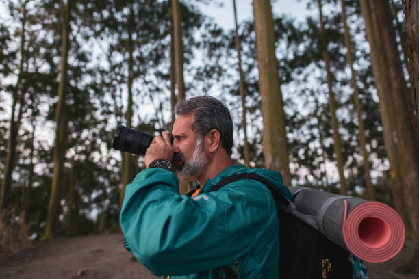istock Active senior hiker taking photos in the wilderness 1460324008