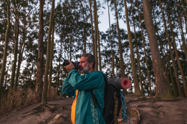 istock Active senior male hiker taking photos in the wilderness 1460324691