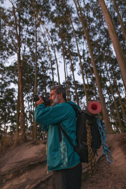 istock Active senior hiker taking photos in the wilderness 1460325311