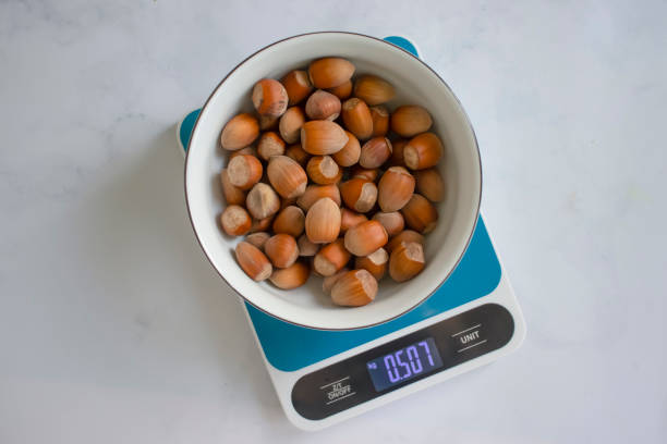 istock Forest nuts, kitchen scales o backgrounddiet, display, balance, gram, weigh, kitchen, scale, kilogram, preparation, electronic, cooking, cook, digital, weight, measurement, measure, lose, antioxidant, energy, background, shell, closeup, food, brown, natur 1460326839
