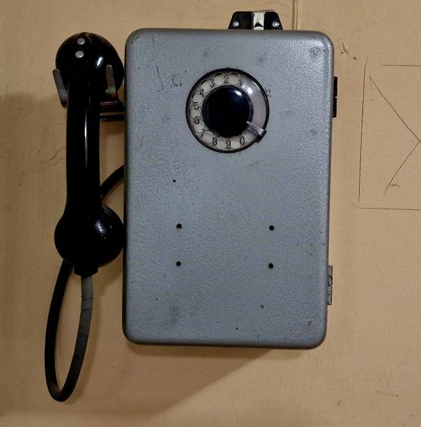 istock an old telephone hangs on a concrete wall 1460330332