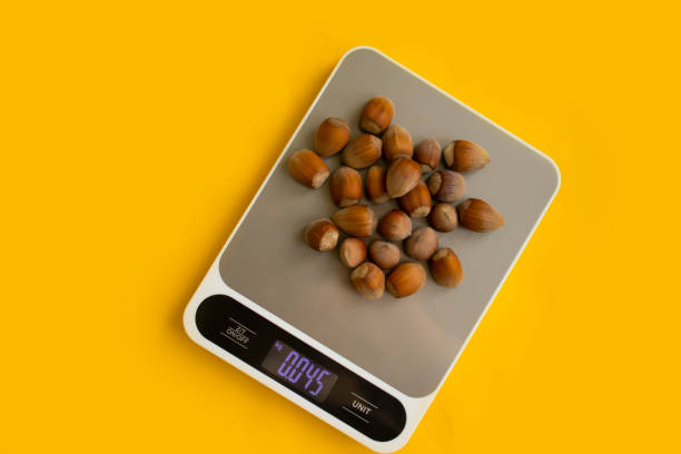 istock Forest nuts, kitchen scales o backgrounddiet, display, balance, gram, weigh, kitchen, scale, kilogram, preparation, electronic, cooking, cook, digital, weight, measurement, measure, lose, antioxidant, energy, background, shell, closeup, food, brown, natur 1460331491