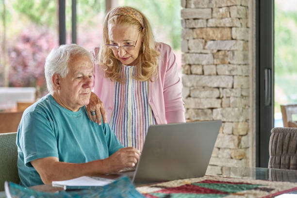istock Active senior couple working on home budget using laptop 1460333458