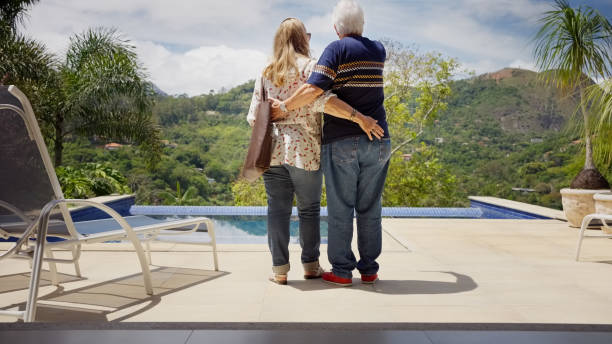 istock Senior couple standing at poolside and looking at the view 1460333505