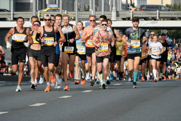 Participants of the Moscow Marathon at a distance. Moscow, Russia - September 18, 2022: Participants of the Moscow Marathon at a distance. marathon stock pictures, royalty-free photos & images