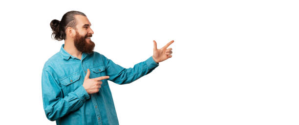 istock Banner size shot of a bearded man pointing aside at white copy space. 1460343771