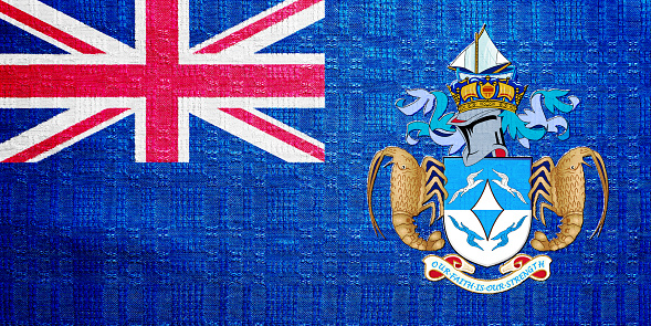 Flag of the British Overseas Territory of the Tristan da Cunha Island on a textured background. Concept collage.