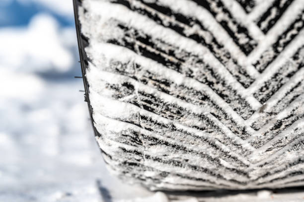 istock Closeup selective focus on snow packed in an all-weather tire tread. 1460350118