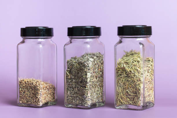 Dried Herbs in Glass Spice Jars stock photo