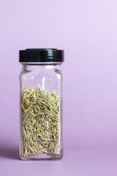 Dried Rosemary Herb  in a Glass Spice Jar stock photo