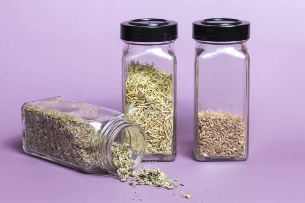 Dried Herbs in Glass Spice Jars stock photo