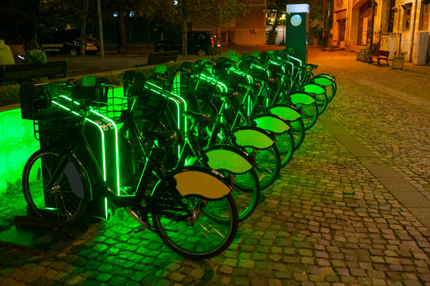 Sustainability in everyday urban life. Urban electric bike share service. City rental bicycles arranged in a row.