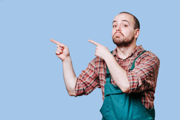 istock Young staring workman in coveralls, emotionally pointing, questioning something. 1460363156