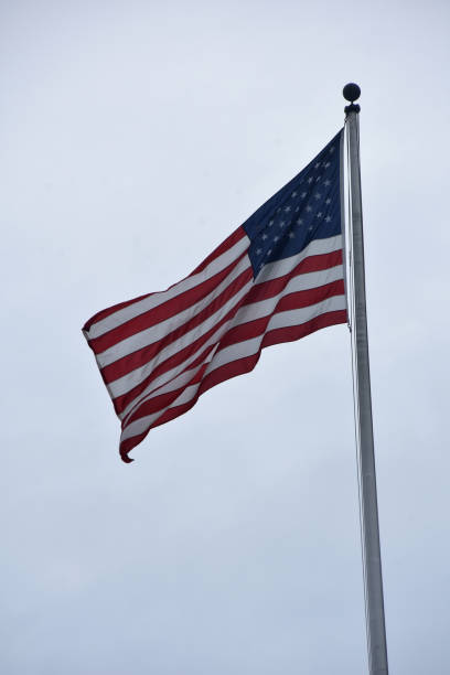 istock American Flag Flying on a Flag Pole 1460365144