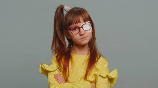 istock Sick ill preteen girl looking at camera, having protective bandage plaster patch scratch on one eye 1460365281