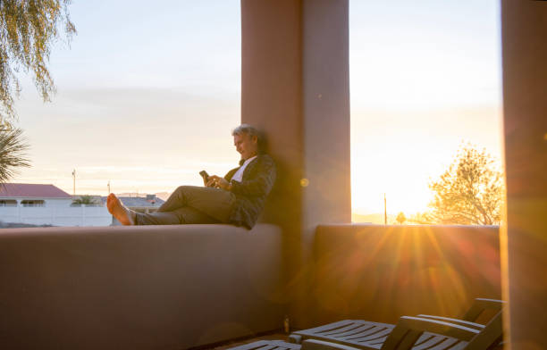 istock Mature man uses mobile phone outdoors 1460369785
