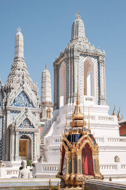 White Temple at Grand Palace Bangkok Thailand vertical front view of historic white Grand Palace in Bangkok with ornamental details on facade and carved columns under cloudless blue sky grand palace bangkok stock pictures, royalty-free photos & images