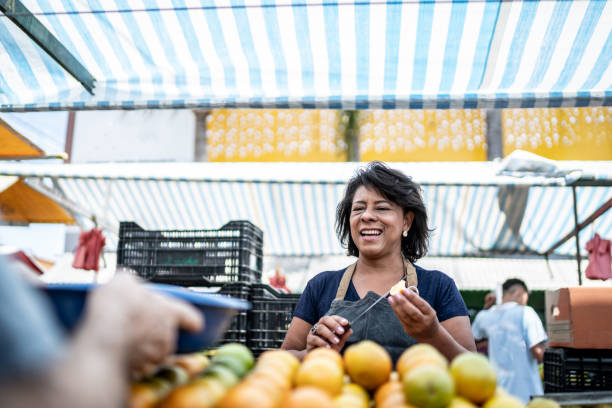 Saleswoman cutting a fruit on a street market