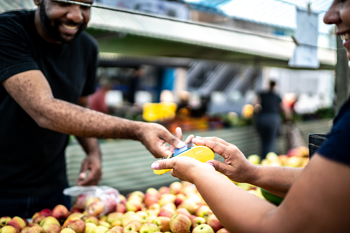 Customer paying with credit card on a street market