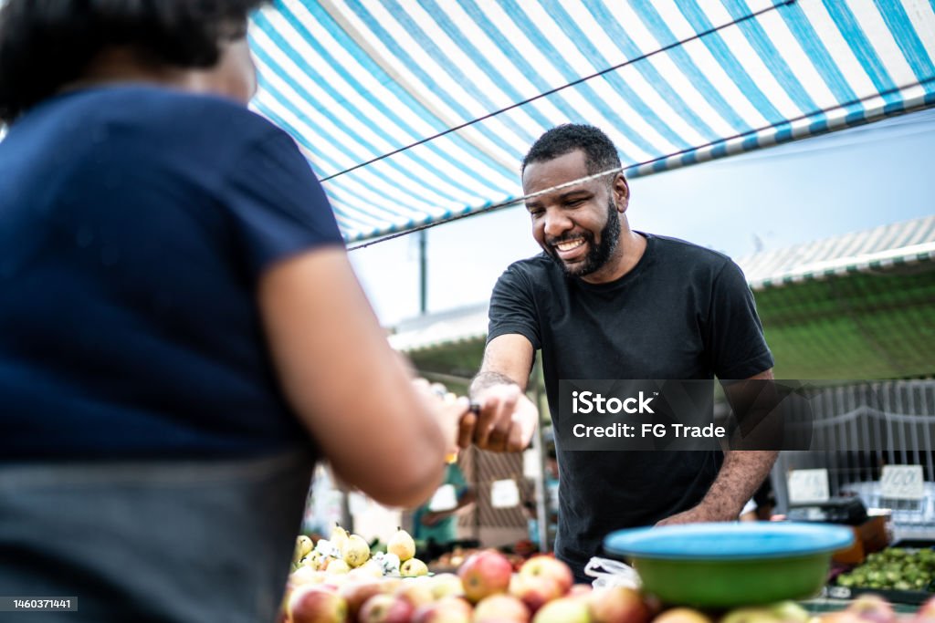 Customer paying with credit card on a street market Credit Card Stock Photo