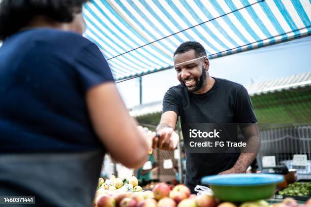 Customer Paying With Credit Card On A Street Market Stock Photo - Download Image Now