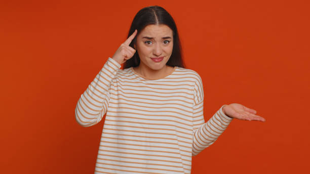 istock Woman pointing at camera and showing stupid gesture blaming some idiot for insane plan, bullying 1460381412