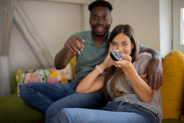 istock Young couple watching TV 1460384764