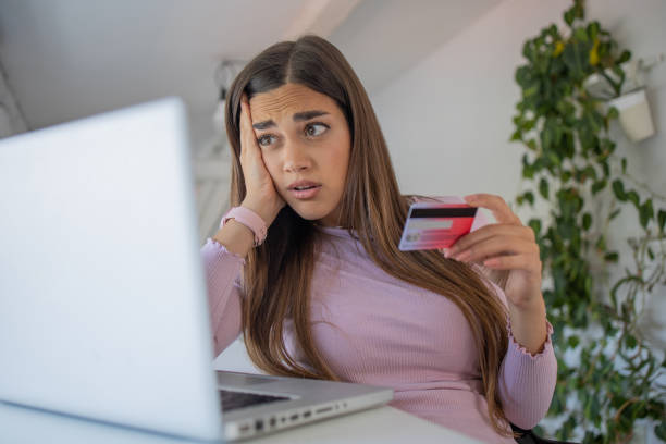 istock Cheerful  young woman doing online shopping 1460385602