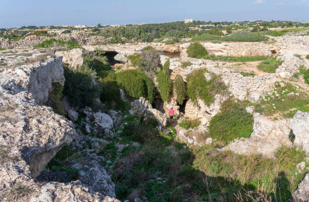 Exploring a sink hole on the island of Malta with caves near Misrah Ghar il-Kbir (Clapham Junction) stock photo