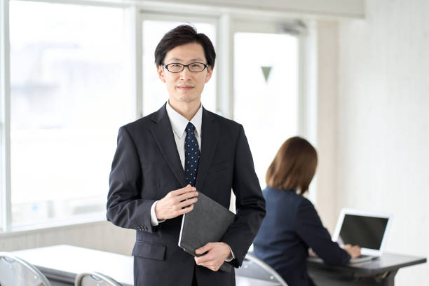 istock Asian businessman with tablet in seminar room 1460394272