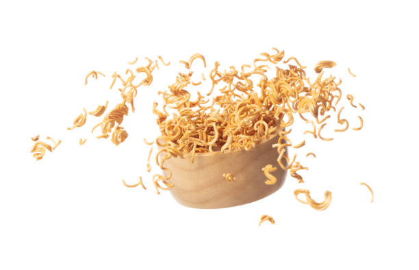 istock Instant Noodle fly in wooden bowl, yellow instant noodle float explode, abstract cloud fly. Curved dried instant noodles splash throwing in Air. White background Isolated high speed shutter 1460395760