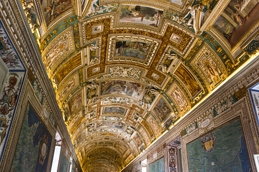 The majestic and stunning frescoed vault inside the church of Sant'Ignazio di Loyola (St. Ignatius of Loyola), in the historic and Baroque heart of Rome. The fresco, depicting the Glory of St. Ignatius, founder of the Society of Jesus (Jesuits), is one of the absolute masterpieces of the Roman Baroque. Painted by the artist Andrea Pozzo in 1685, this fresco almost entirely covers the vault of the church with a perspective representation that, between arches, clouds and columns, increases its space and volumes, effectively creating a virtual reality. The work depicts Christ (in the center) who radiates the figure of St. Ignatius and at the corners the allegories of the four continents known until then. In 1980 the historic center of Rome was declared a World Heritage Site by Unesco. Super wide angle image in high definition format.