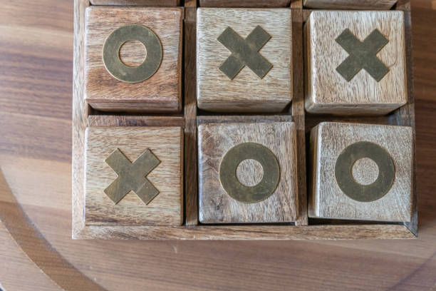 istock Tic Tac Toe board game wood block cubes to play 1460396398