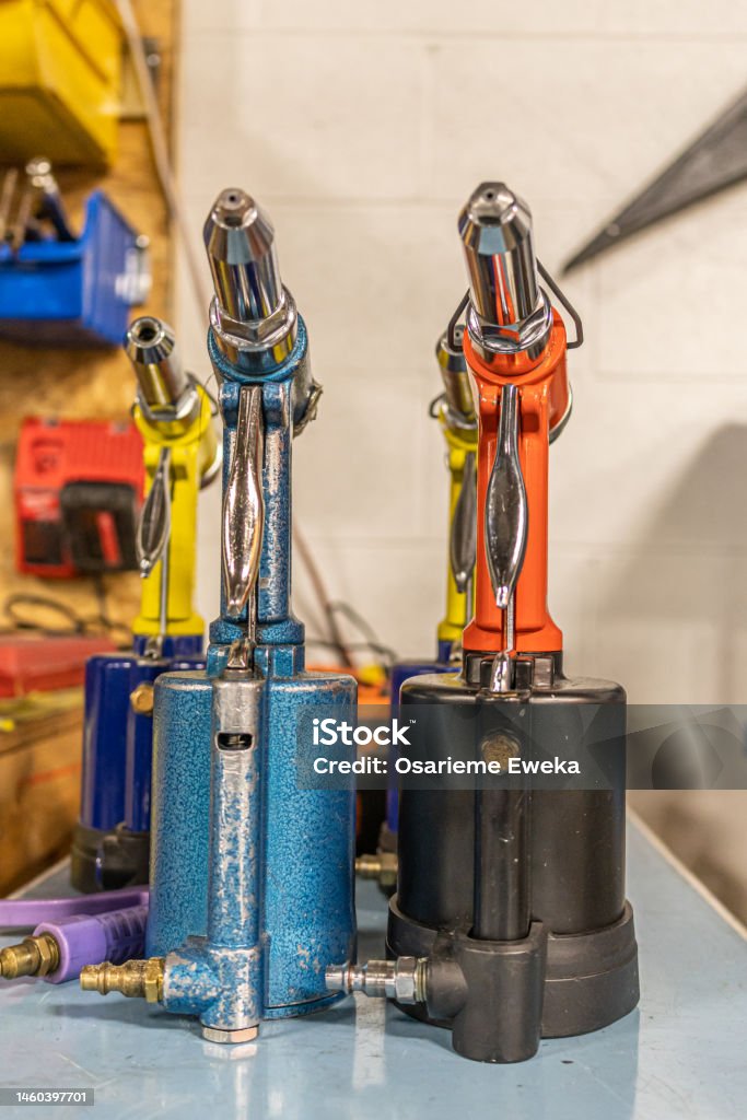 pneumatic Rivet Guns in a metal factory to fabricate pneumatic Rivet Guns in a metal factory Color Image Stock Photo