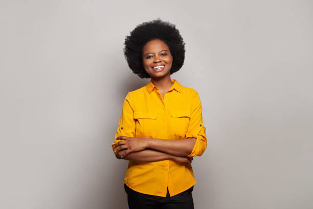 istock Business woman smiling at camera with crossing hands on white studio background 1460418390