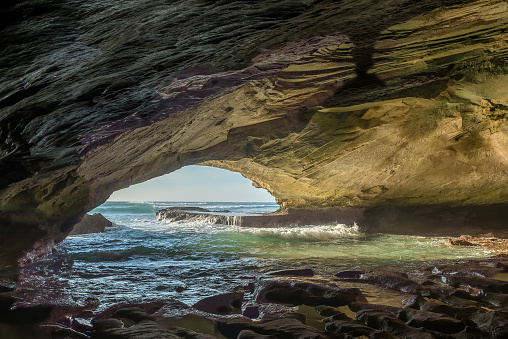 Inside the Waenhuiskrans Cave near Arniston in the Western Cape Province. The Indian Ocean is visible