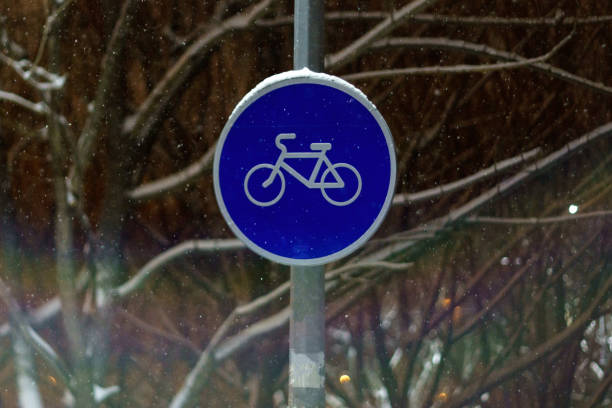 istock Round bicycle sign transit for bicycles. Bicycle road sign. Winter, night. Selective focus 1460428763