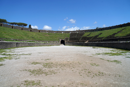 Ruins of Roman amphitheater, Pompeii famous ancient city archaeological site, popular tourist guided tour destination, Pompei, Italy