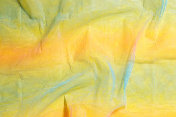 istock Texture of multicolored transparent yellow fabric background, homework, hobbies, knitting, needlework 1460429984
