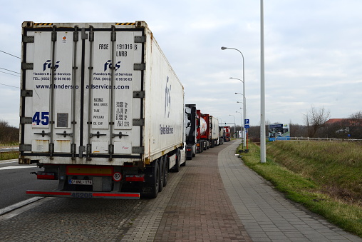 Blankenberge, West-Flanders, Belgium - January 28, 2023: only parking zone for trucks along the Kustlaan towards Zeebrugge. During the weekend when not working truck drivers from Zeebrugge stand still  in Blankenberge
