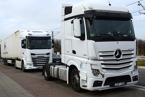 Blankenberge, West-Flanders, Belgium - January 28, 2023: only truck parking space. DAF trucks and Mercedes Benz whole weekend parked along the Kustlaan road. Zeebrugge transport activities during week