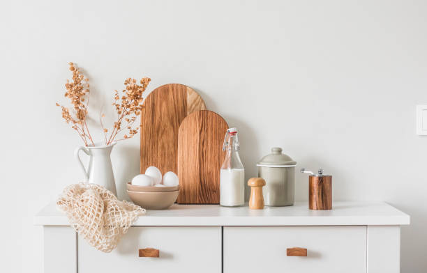 istock Scandinavian style, natural, minimalism kitchen interior. Kitchen dresser with egg bowl, chopping boards, jug and cooking utensils 1460433266