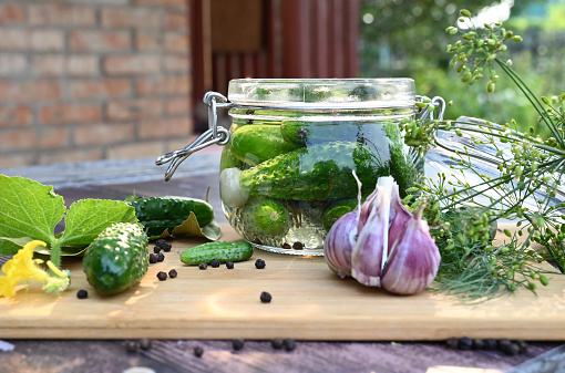 a set of ingredients for pickling cucumbers, pickled cucumbers, brine.