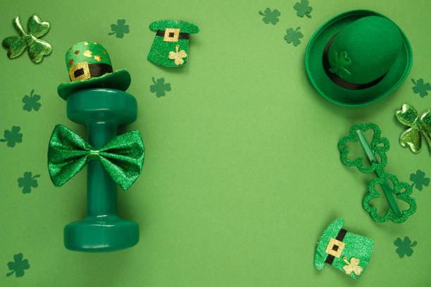 istock St. Patrick's Day flat lay composition with gym dumbbell, green decorations and copy space. 1460437419