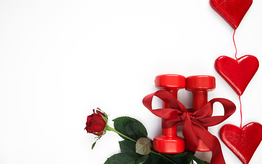 Intricate & Festive Red & Pink Roses With a Rattan Background in Bright Natural Light for Valentine's Day in 2023.